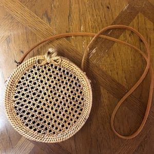 Woven straw round crossbody handbag by Dewi